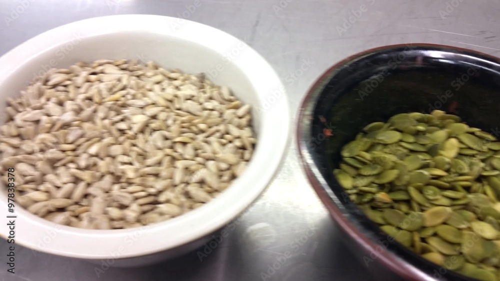 Sunflower-, pumpkin- and linseed seeds, in porslin bowls, at a restaurant kitchen Sunflower-, pumpkin- and linseed seeds, in porslin bowls, at a restaurant kitchen