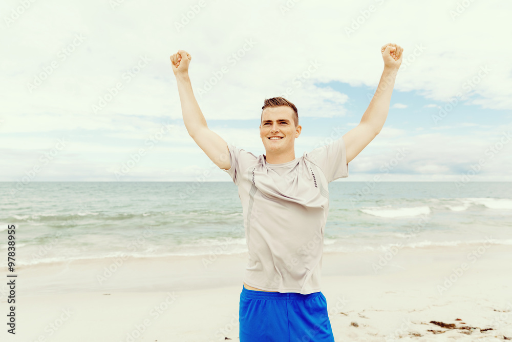 Young man in sport wear with outstretched arms Young man in sport wear with outstretched arms