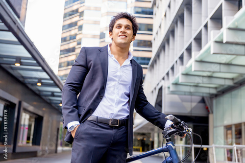 Successful businessman riding bicycle