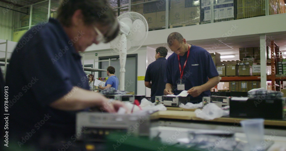 Workers building computers in a British electronics factory Workers building computers in a British electronics factory
