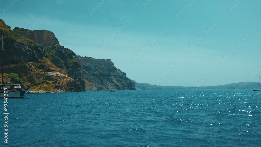A POV holiday and vacation experience showing a clipper boat departing from the ancient port of Fira in Santorini island, Greece
A POV holiday and vacation experience showing a clipper boat departing from the ancient port of Fira in Santorini island, Greece
