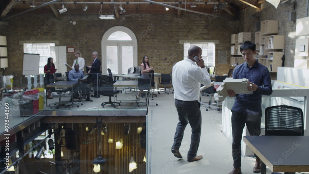 Diverse business group at work in busy modern office Diverse business group at work in busy modern office