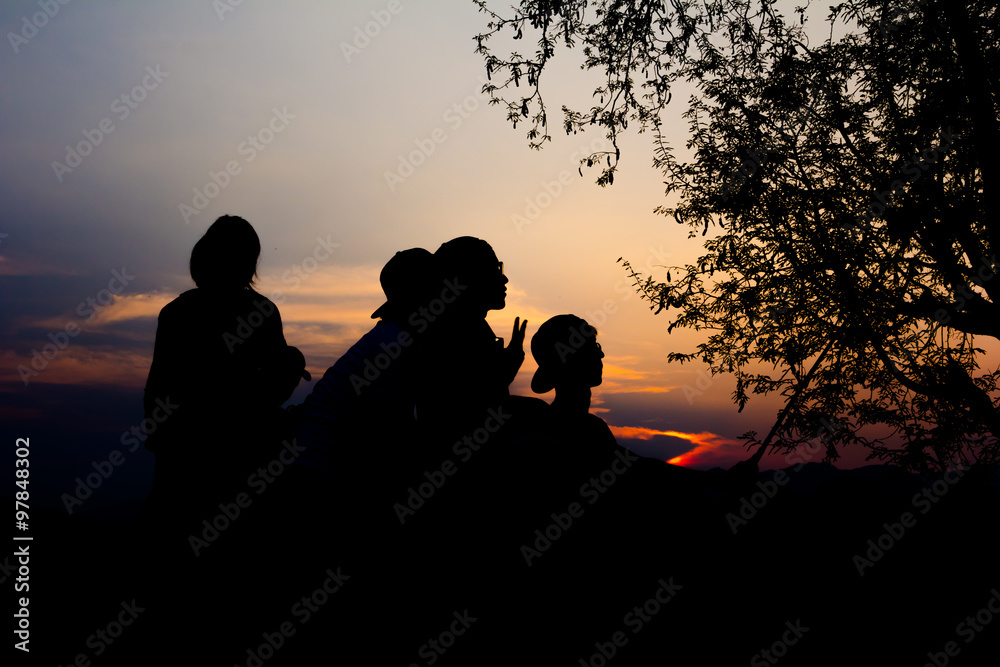 Silhouette of travelers enjoy their moment watching sunset