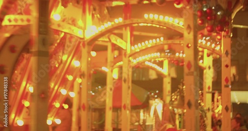 Children ride as parents watch the local merry go round at the community festival.