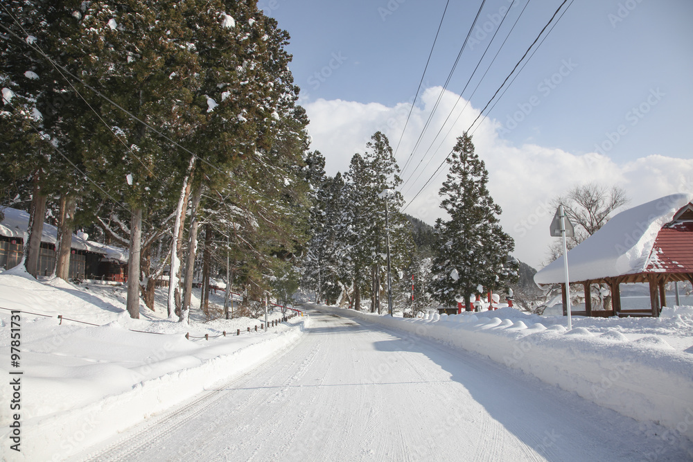 Fototapeta premium Snow road near Gozaishi shrine located by Lake Tazawa in Akita,