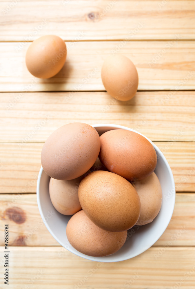 hen eggs in bowl on wood background hen eggs in bowl on wood background