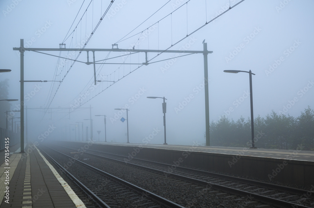 Empty platform of a train station on a foggy day in autumn. Empty platform of a train station on a foggy day in autumn.