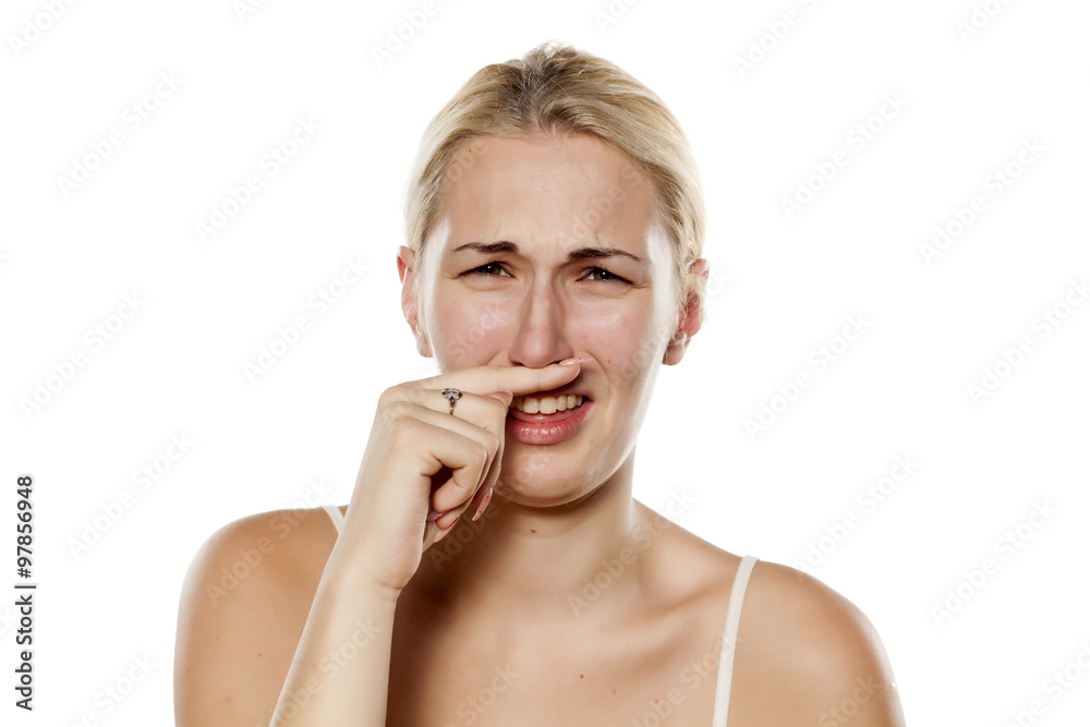 young blonde is squeamish because of the odor young blonde is squeamish because of the odor