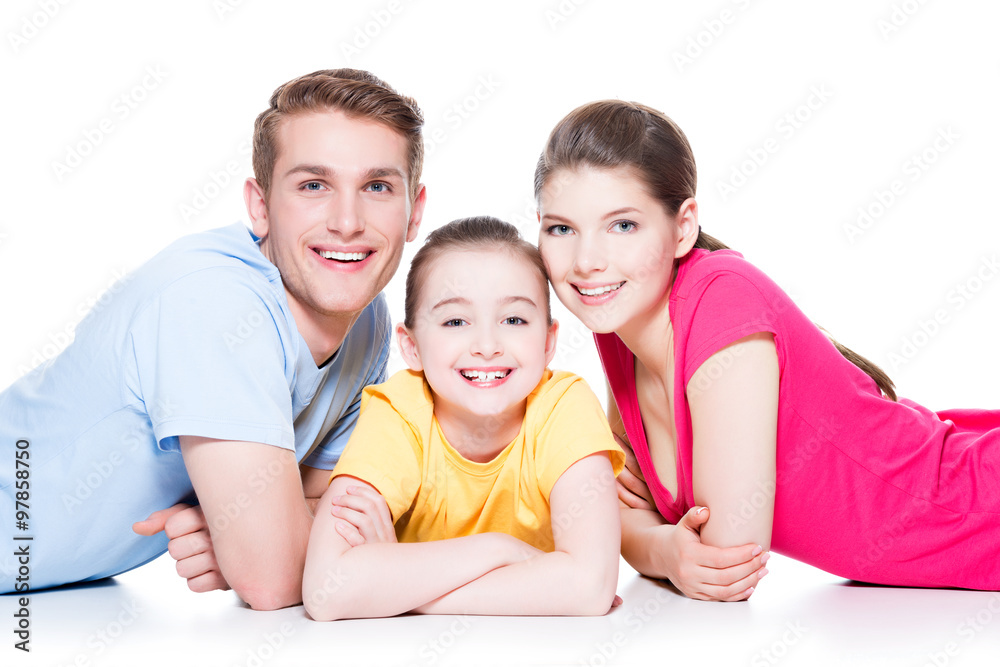 Smiling family with kid sitting in colorful shirt. Smiling family with kid sitting in colorful shirt.