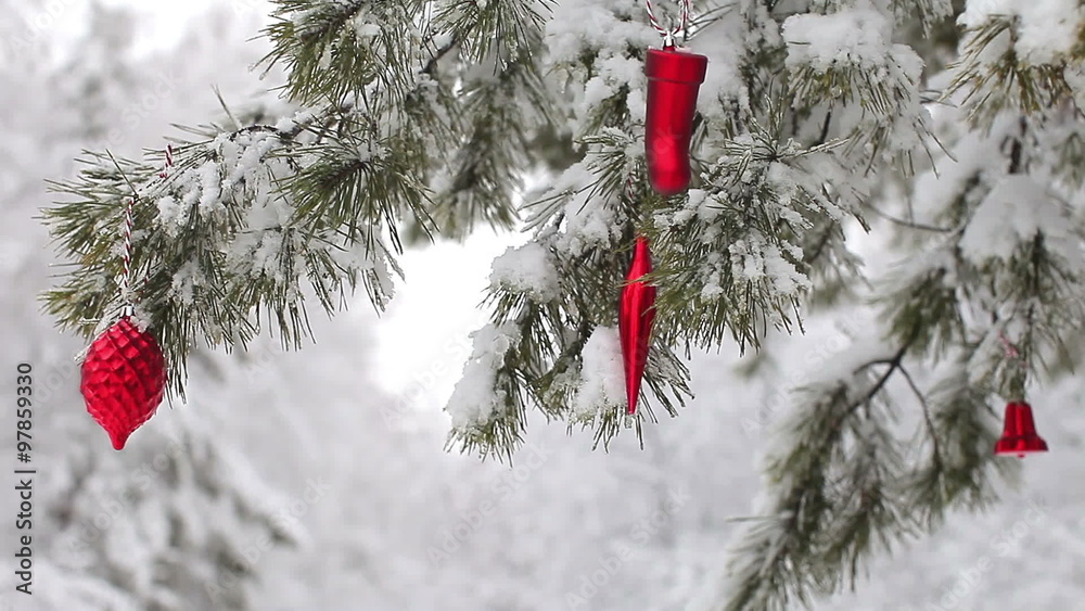 red toys swinging on a tree branch in the winter forest red toys swinging on a tree branch in the winter forest