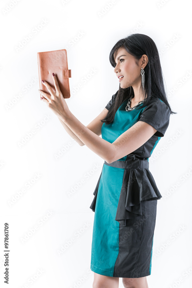Fototapeta premium Woman wearing a green dress with documents in hand.