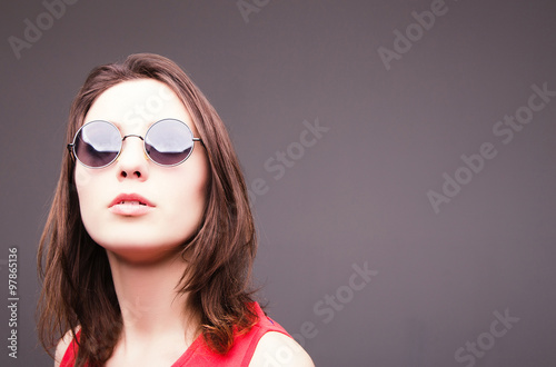 Fashion portrait of a beautiful brunette woman in glasses