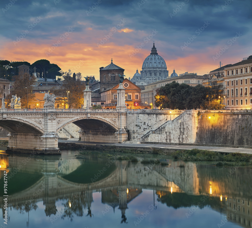Rome. View of Vittorio Emanuele Bridge and the St. Peter's cathedral in Rome, Italy during sunset.