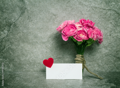 Fresh pink carnation flower and blank card for copy space 