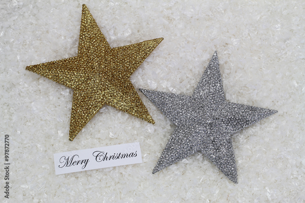 Merry Christmas card with silver and golden glittering stars on snowy surface
Merry Christmas card with silver and golden glittering stars on snowy surface