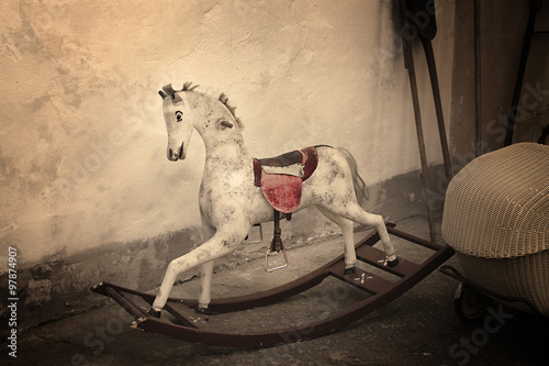 A vintage old rocking horse in a rustic setting.