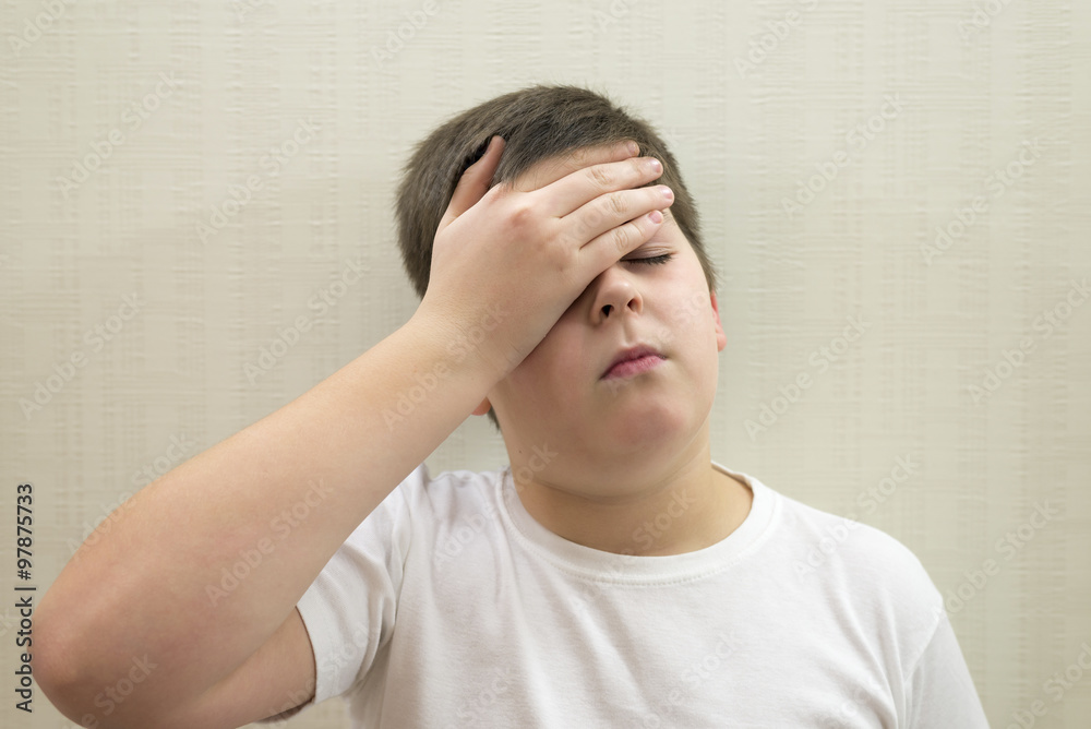 Portrait of teenage boy with a headache Portrait of teenage boy with a headache