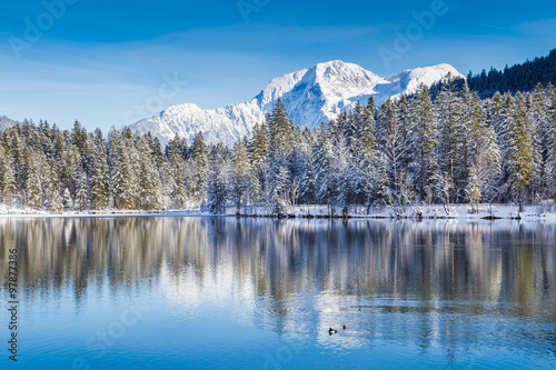 Idyllic winter wonderland with mountain lake in the Alps