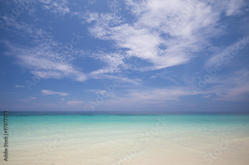 tropical beach with blue sky and calm blue sea surf © Sunanta