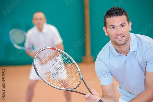Men playing doubles tennis © auremar