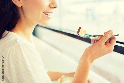 close up of woman eating cake at cafe or home