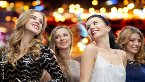 happy young women dancing at night club disco