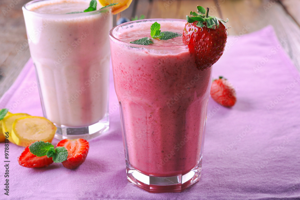 Glasses of fresh cold smoothie with fruit and berries, on the table, close-up Glasses of fresh cold smoothie with fruit and berries, on the table, close-up