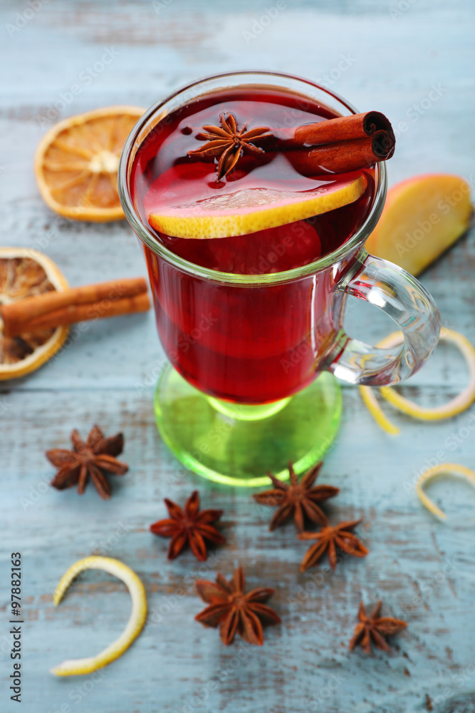 Tasty mulled wine and spices, on blue wooden background, close-up Tasty mulled wine and spices, on blue wooden background, close-up