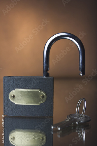 lock and key on a brown background photo