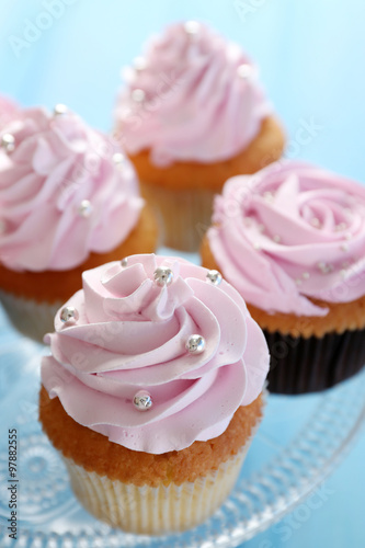 Tasty cupcakes on color wooden background