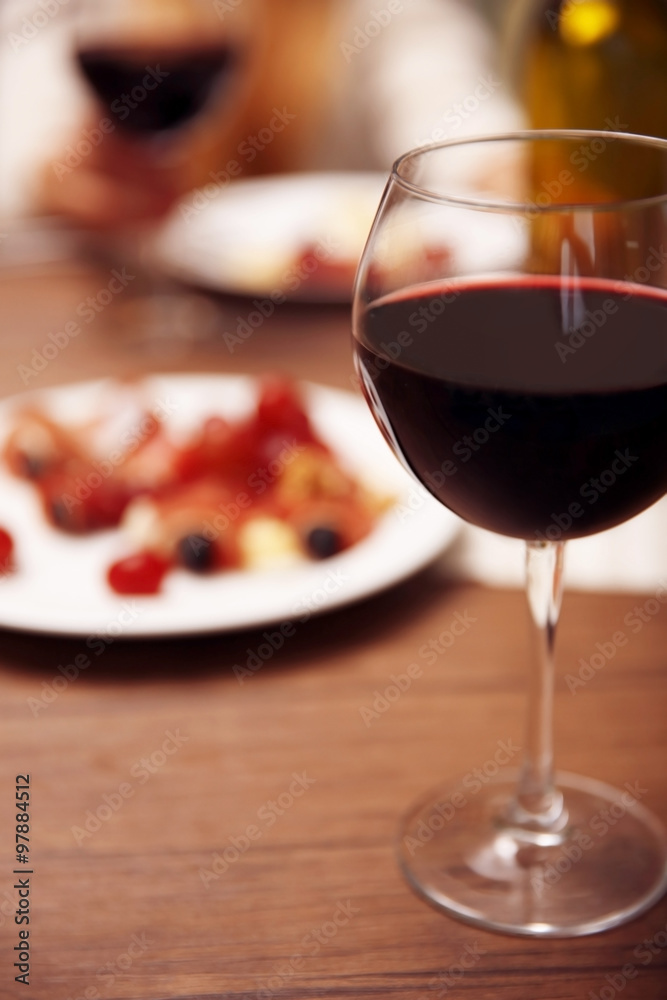 Glass with red wine on the table Glass with red wine on the table