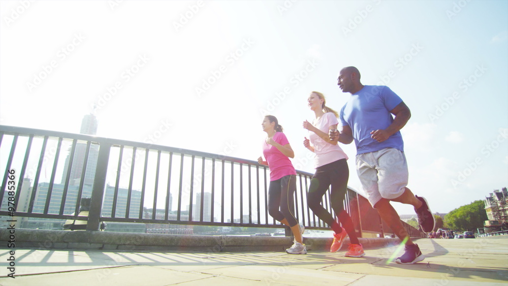  Fitness instructor with 2 female clients going for a run in the city