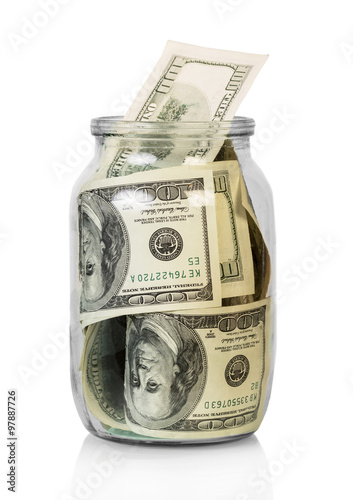 Dollars in glass jar isolated on white