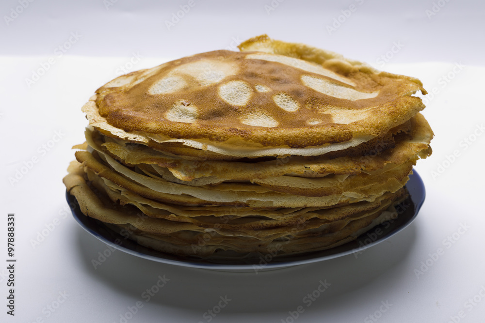 Pancakes on a plate on a white background