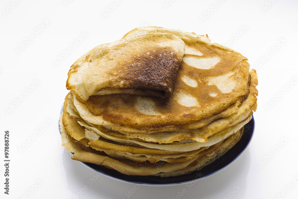 Pancakes on a plate on a white background Pancakes on a plate on a white background