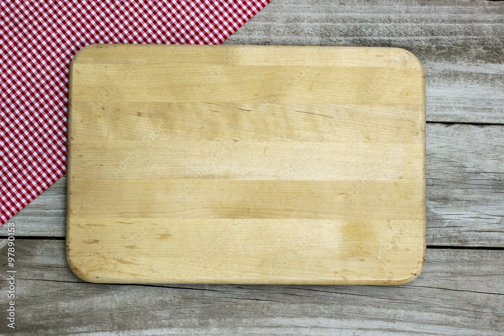 Blank cutting board with napkin border on wood background Stock Photo