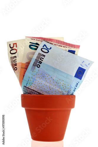 Des billets qui poussent dans un pot de fleurs  photo