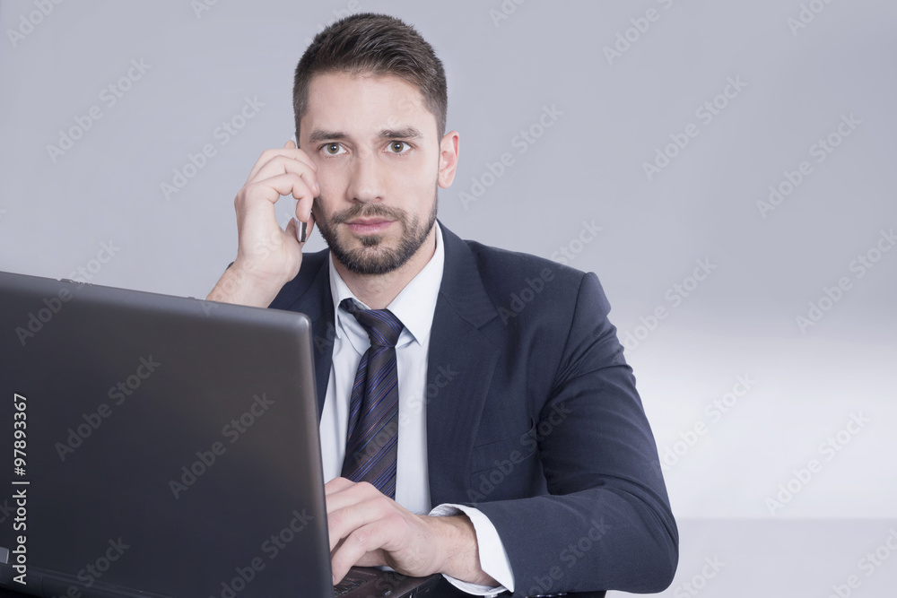 Businessman on a phone and lap top 