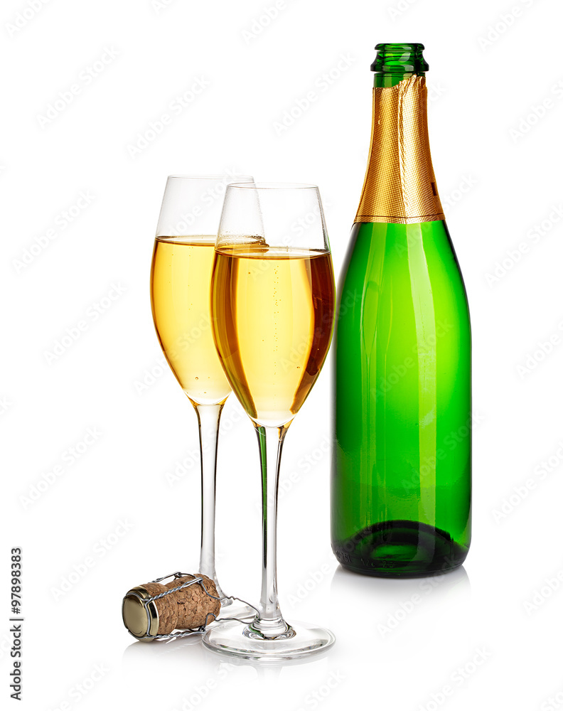 Two elegant champagne glasses on the background of green bottles close-up isolated on a white. Festive still life. Two elegant champagne glasses on the background of green bottles close-up isolated on a white. Festive still life.