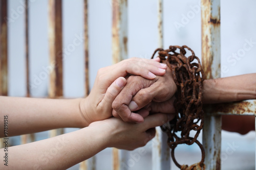 women hand holding prisoner hand. Fototapet