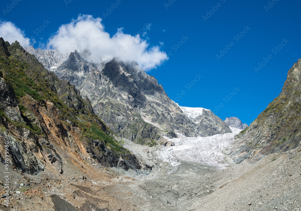 mountain glacier on the slope of a rocky peak