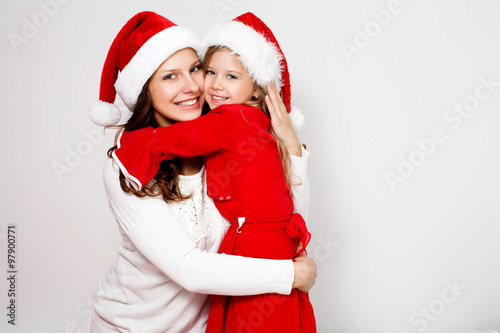 Happy family in Christmas caps. Mother and daughter