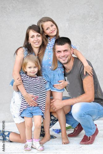 portrait of a happy family in the summer on the nature © zagorodnaya