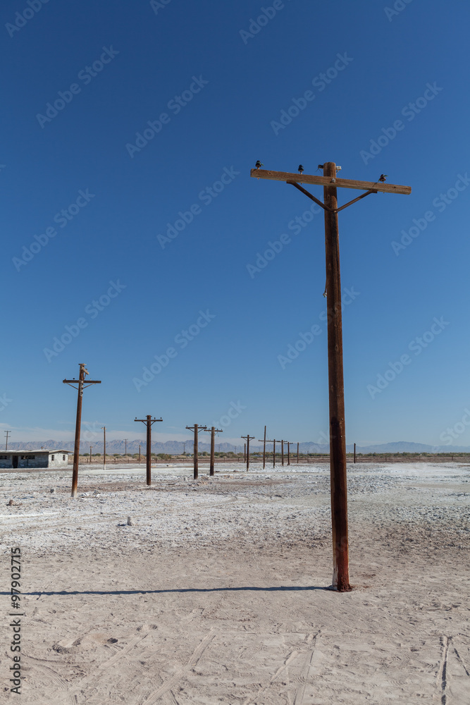 Telephone post in barren wasteland.
