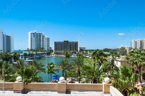 Luxury resort buildings at Sarasota Bay in Florida USA. Architectural residential condominiums for holidays and vacation with palm trees against blue sky background photo