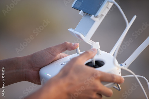 Drone operator using a remote control.