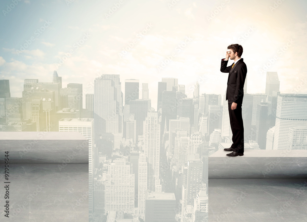 Businessman standing on the edge of rooftop Businessman standing on the edge of rooftop
