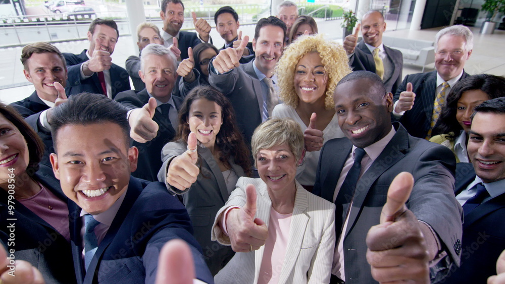  Portrait of large diverse business group giving thumbs up to the camera