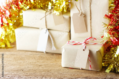 gift box with tag and Christmas decoration on wood table 