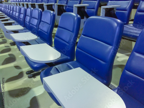 blue chairs seats in empty auditorium